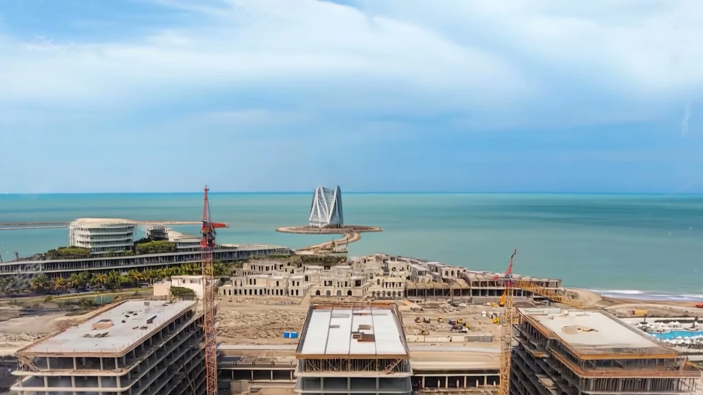 New front-line buildings under construction, cranes and the reclaimed land behind them