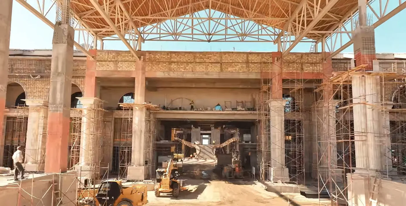 A hall under the wooden trusses of the future roof